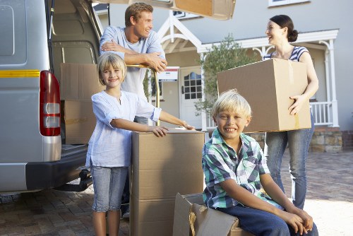 Removal team loading household items into a van