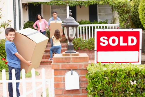 House removal team transporting boxes and furniture during a Brockley home move