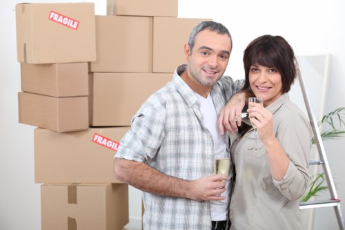 Local movers carrying household items during a Brockley flat move